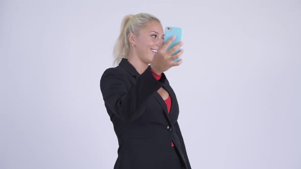 Young Happy Blonde Businesswoman Video Calling and Showing Phone