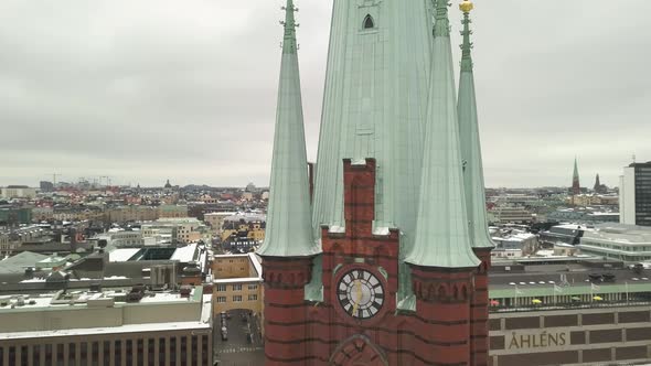 Close up aerial shot rotating around clock tower of Saint Clare Church showing intricate detail  of