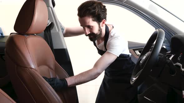 Man Washing His Car in a Garage