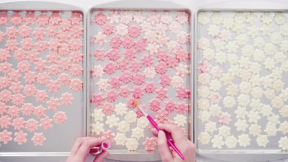 Flat lay. Step by step. Dusting chocolate snowflakes with glittery food dust.