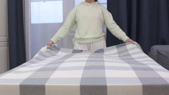 Woman Laying Tablecloth on Dining Table in Slow Motion