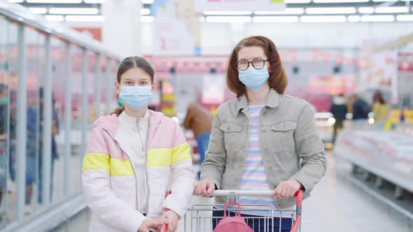 Mom and Daughter Posing in Supermarket During Pandemic