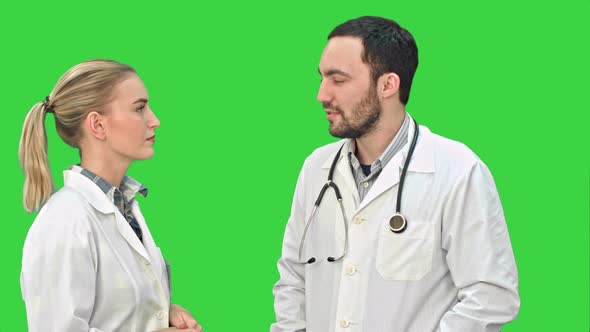 Two Medical Professionals Discuss with a Patient on a Green Screen, Chroma Key