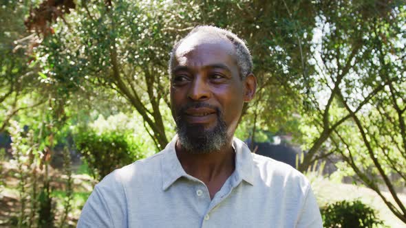 Portrait of senior african american man smiling in a sunny garden