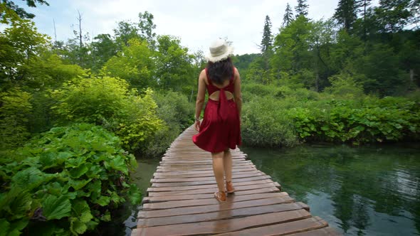Woman Traveler Enjoys Waterfall in Plitvice Lakes