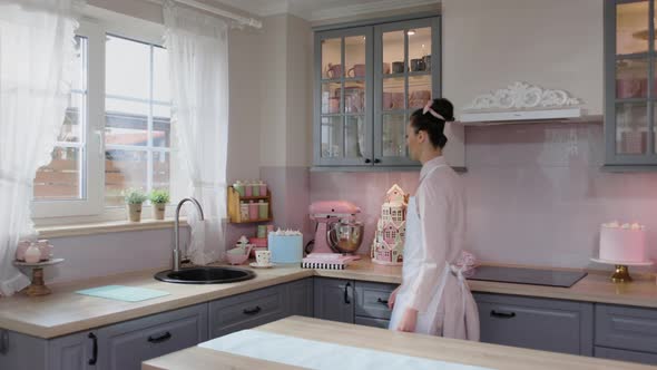 Chef Woman in Apron Having a Cup of Coffee or Tea in the Morning before Cooking in Pastry Shop