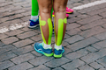 kinesio tape on calf muscles female runner before marathon - PhotoDune Item for Sale