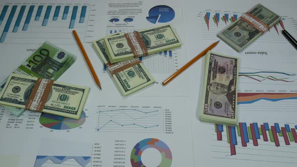 Business Graphics And Money On The Table