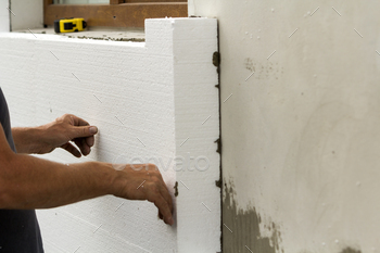 oam sheet on plastered brick wall. Modern technology, renovation, insulation concept.