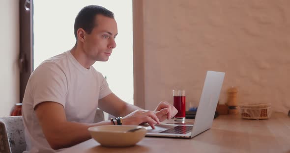 Freelancer Man Works By Laptop PC in Cafe