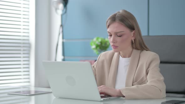 Businesswoman Talking on Video Call on Laptop in Office