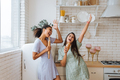 two girls of different races having fun in the kitchen - PhotoDune Item for Sale