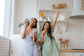 two girls of different races having fun in the kitchen - PhotoDune Item for Sale