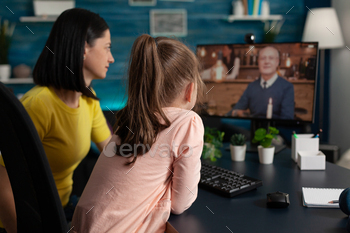 Smart school girl and mom on online conference