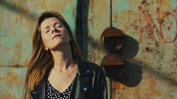 Portrait Rebel Beautiful Woman in Aleather Jacket Puts on Sunglasses and Go Away