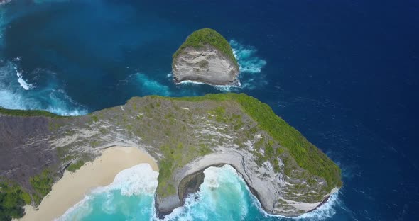 Aerial drone view of a secluded deserted beach coastline.