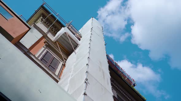 Building with White Fabric on High Metal Scaffolding