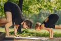 Man and woman doing yoga exercises in the park - PhotoDune Item for Sale