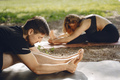 Man and woman doing yoga exercises in the park - PhotoDune Item for Sale