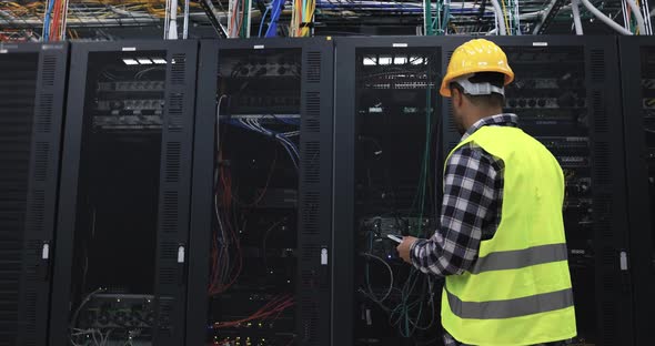 Technician man at work inside server room