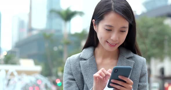 Woman work on cellphone at outdoor