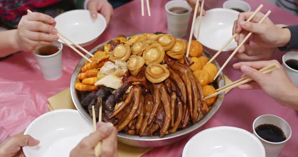 Traditional Chinese family eating big bowl feast together at home