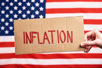hold paper sheet with word inflation against american flag, Rising prices for consumer goods and services