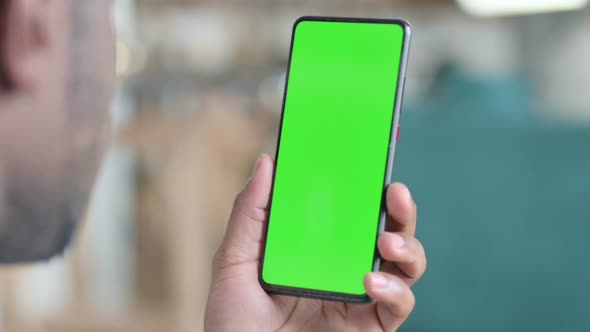 Close Up of African Man Using Smartphone with Green Chroma Screen