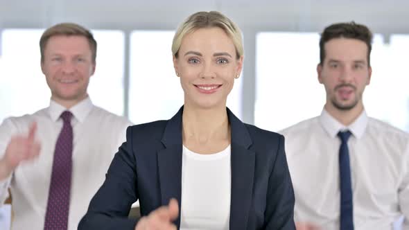 Portrait of Attractive Businesswoman Standing with Team and Showing Thumbs Up