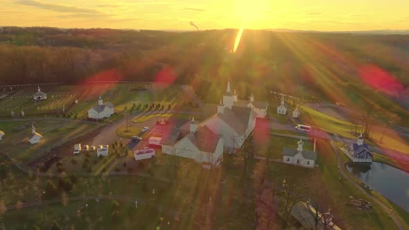 Late Afternoon Fall Aerial View with Sun Rays of Beautiful Restored Barns