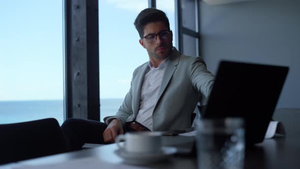 Serious Businessman Looking Documents in Luxury Office