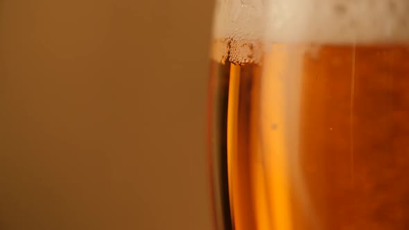 Pouring Fresh Beer Golden Background