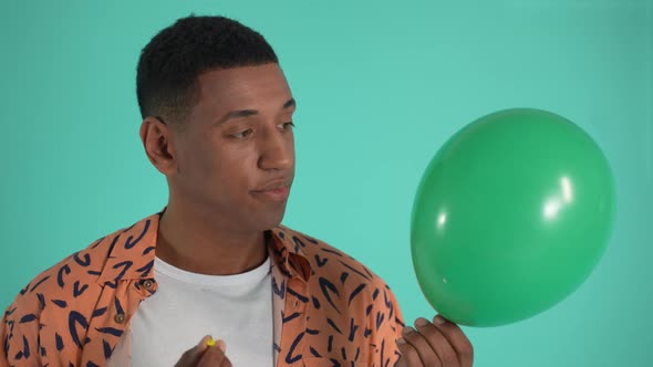 Disappointed African American Man Popping Balloon