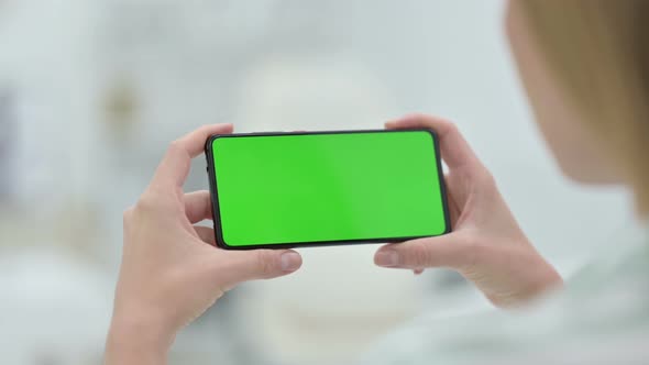 Woman Watching Smartphone with Green Key Chroma Screen
