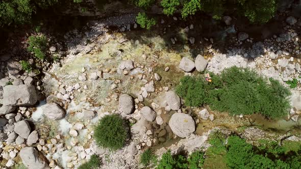 Aerial view of a person passing through the Soca River on a zip line in Slovenia