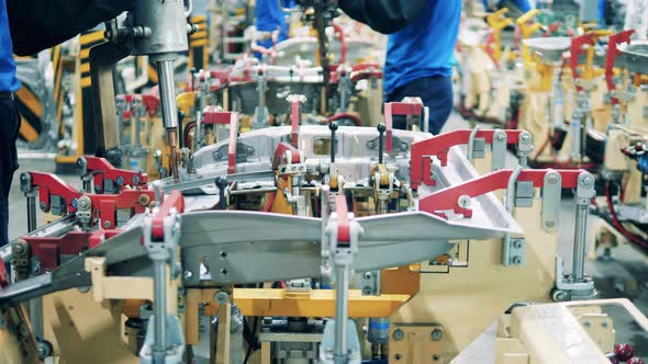 Car Workers Using Welding Machines To Weld Car Body Parts