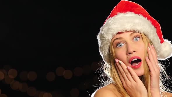 Very Hot Blonde in Christmas Cap, Isolated on Black, Сlose Up. Slow Motion