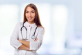 Medical physician doctor woman over blue clinic background - PhotoDune Item for Sale