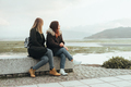 Two female friends sitting on a bench - PhotoDune Item for Sale