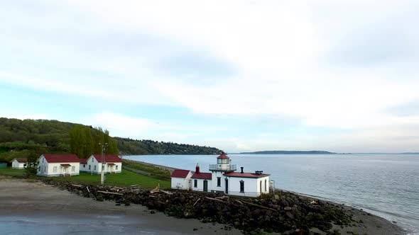 Drone view zooming by the Discover Park lighthouse in Seattle, Washington.