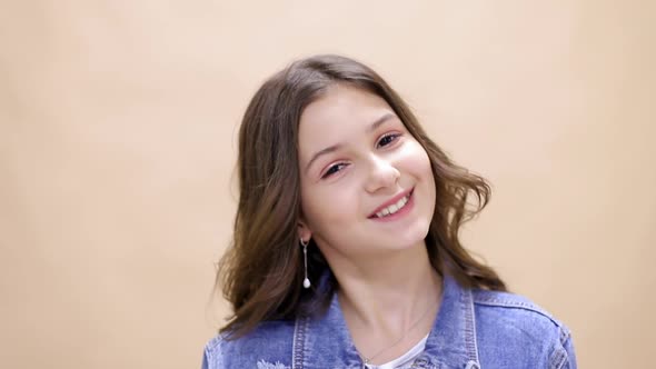 Portrait of a teenage girl girl on a yellow background