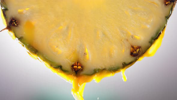 Flowing Pineapple Juice From Pineapple Slice Macro Shot in Slow Motion