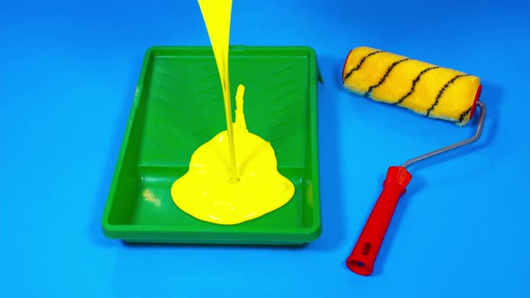 Close Up of Yellow Paint Pouring in Plastic Tray