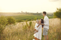 Mother, father and son in white clothes walking on the field - PhotoDune Item for Sale