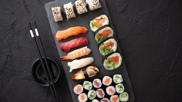 Sushi Rolls Set with Salmon and Tuna Fish Served on Black Stone Board