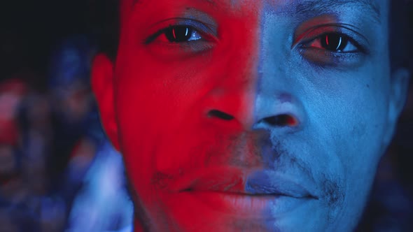 Portrait of Young Handsome African American Man in Multicolored Neon Light