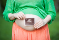 Pregnant woman with ultrasound image of a baby - PhotoDune Item for Sale