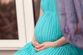 Pregnant woman on the window sill - PhotoDune Item for Sale