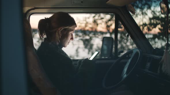 Woman Texting on Smartphone in Van
