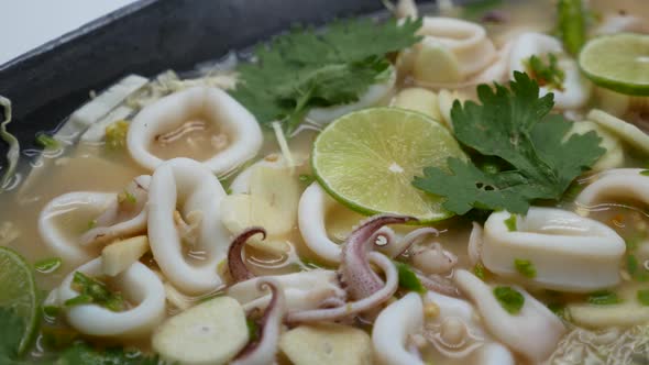 Close-Up Footage of Hot and Sour Squid in Chilli, Garlic and Lime Soup